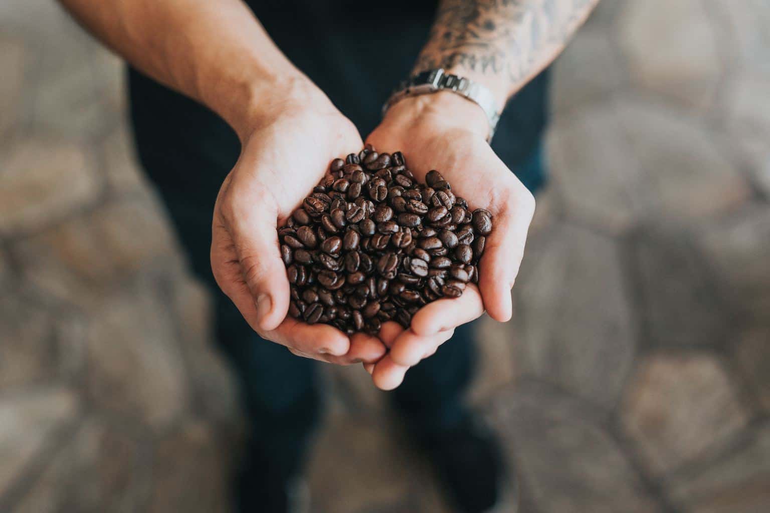 man holding a bunch of coffee beans