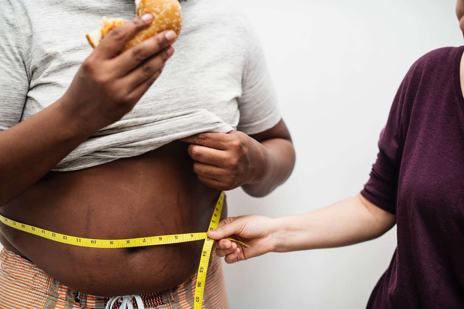 image of a person measuring someone's waist line