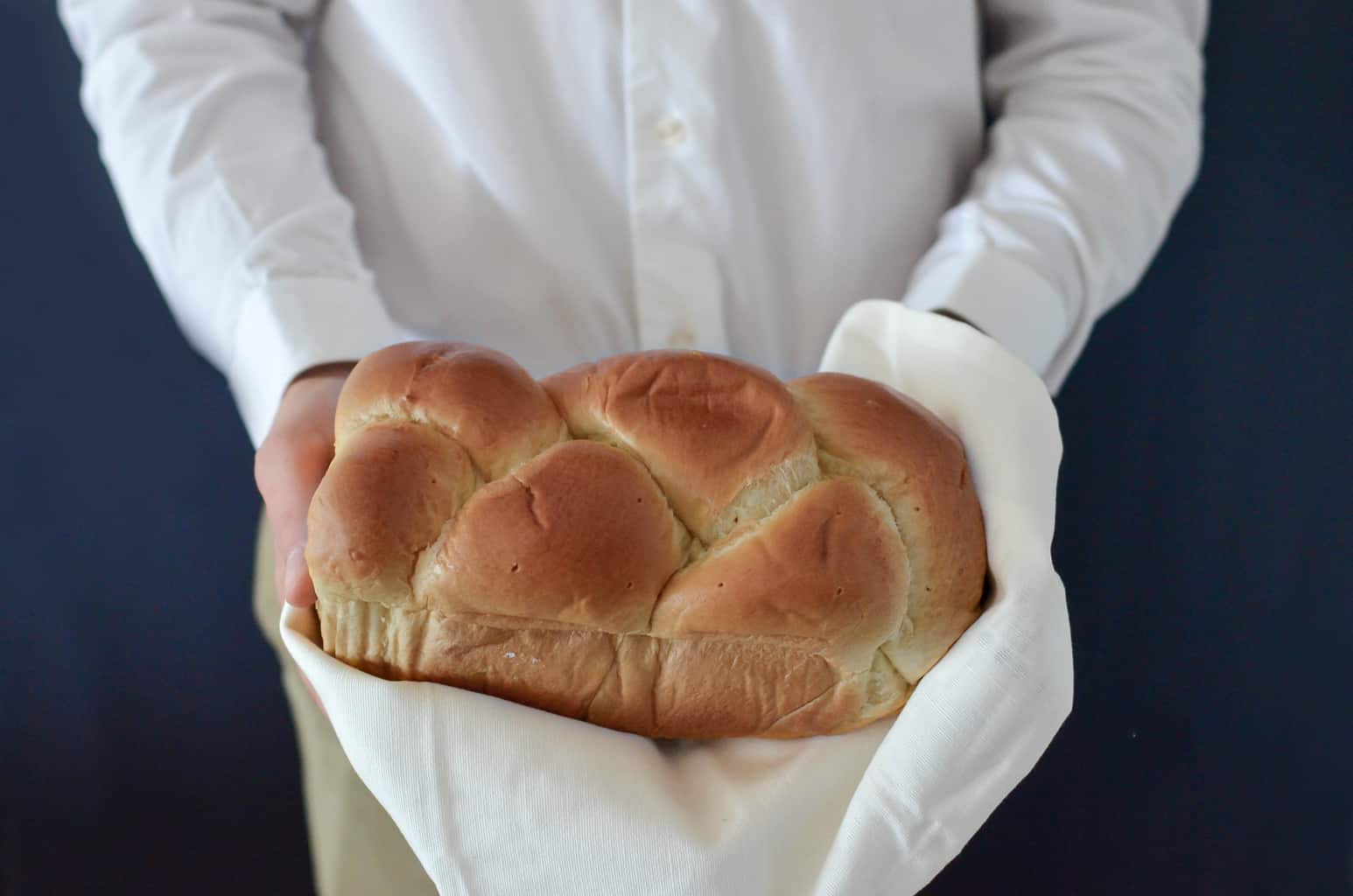 person holding a loaf of bread that contains gluten