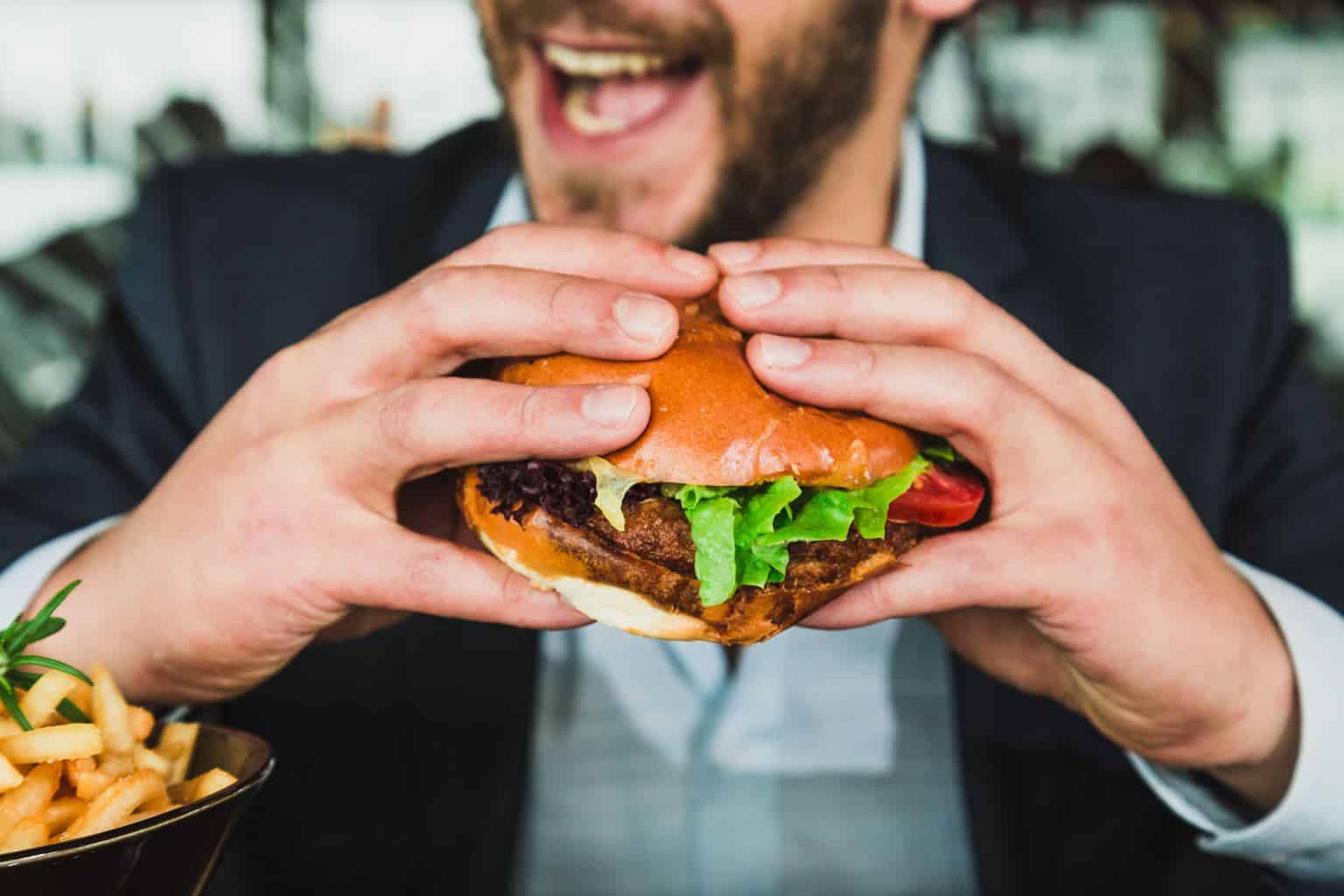 a man holding a burger